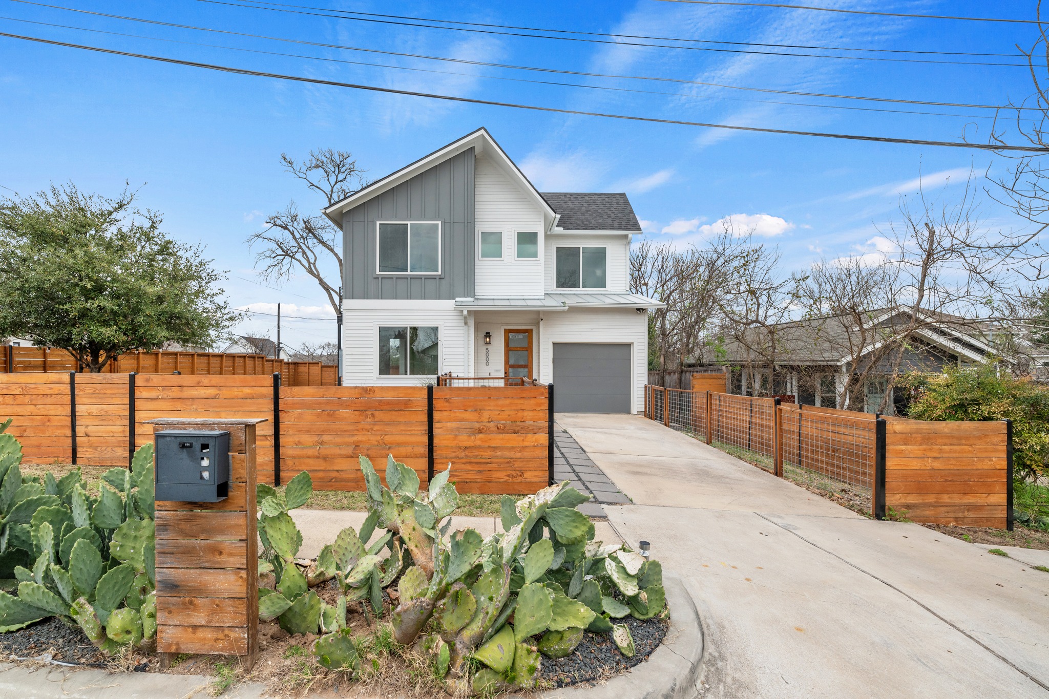 Custom cactus beds surrounding the mailbox bring a distinct East Austin touch to the front approach