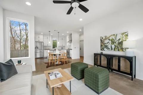 a living room with furniture and a wooden floor