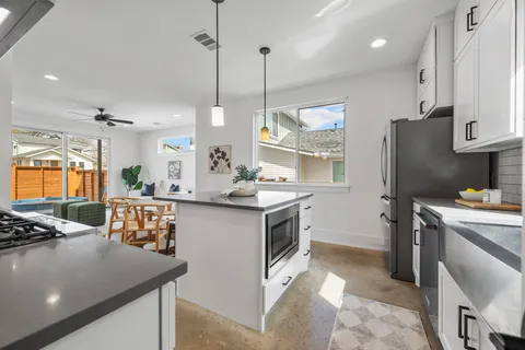 a kitchen that has a lot of cabinets in it and appliances