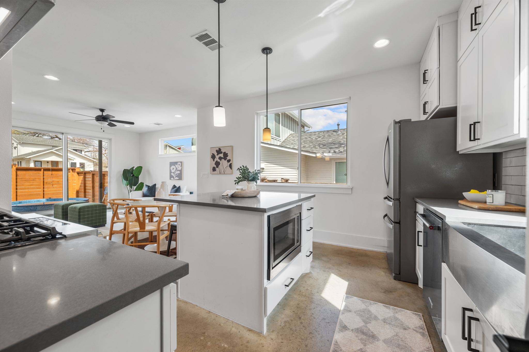 5000 Baker Street Austin, TX 78721 - Photo 17 of 40 The oversized stainless farmhouse sink sits beneath a striking glass tile backsplash, adding texture and character to the workspace