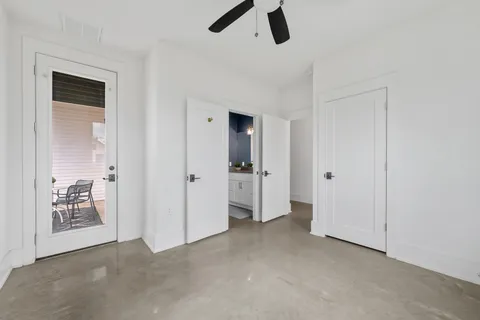 an empty room with closet and windows