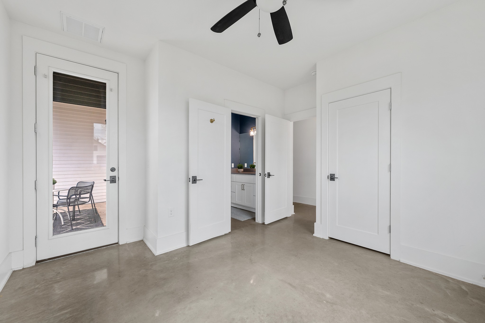 5000 Baker Street Austin, TX 78721 - Photo 20 of 40 Located on the main level near the full bathroom, this bedroom provides a convenient layout for visitors along with direct access to the back patio