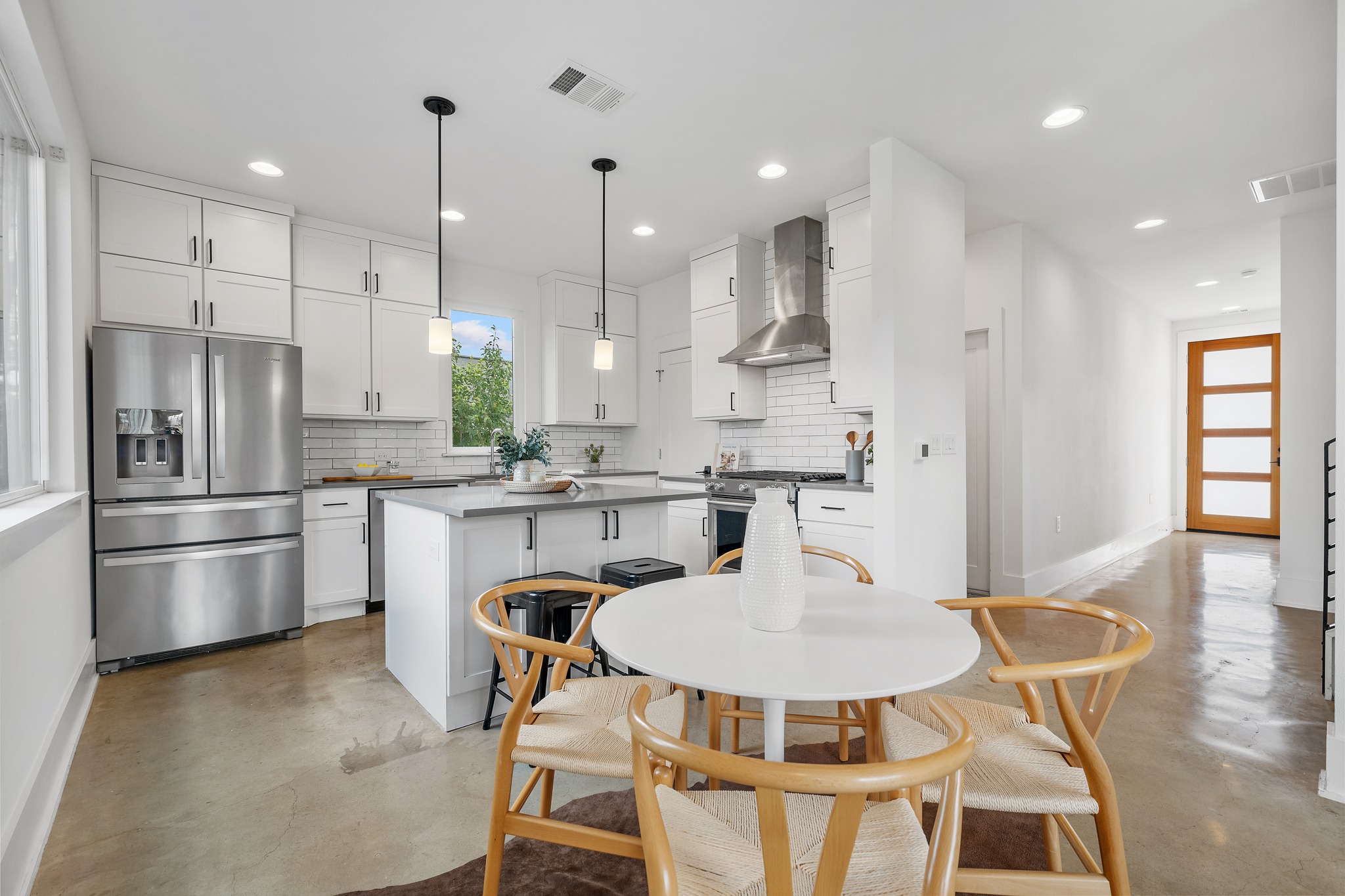5000 Baker Street Austin, TX 78721 - Photo 2 of 40 The dining area sits naturally between the living room and kitchen, creating a central gathering spot where meals, conversations, and everyday routines come together