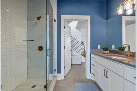 a bathroom with a shower and a sink