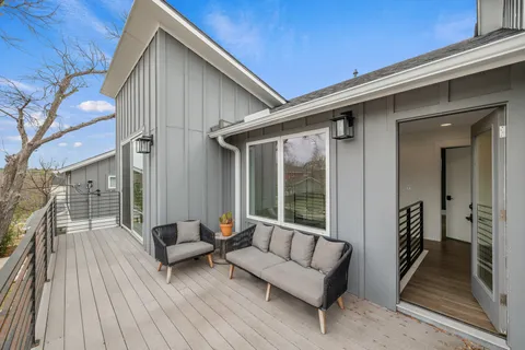 a balcony with furniture and wooden floor