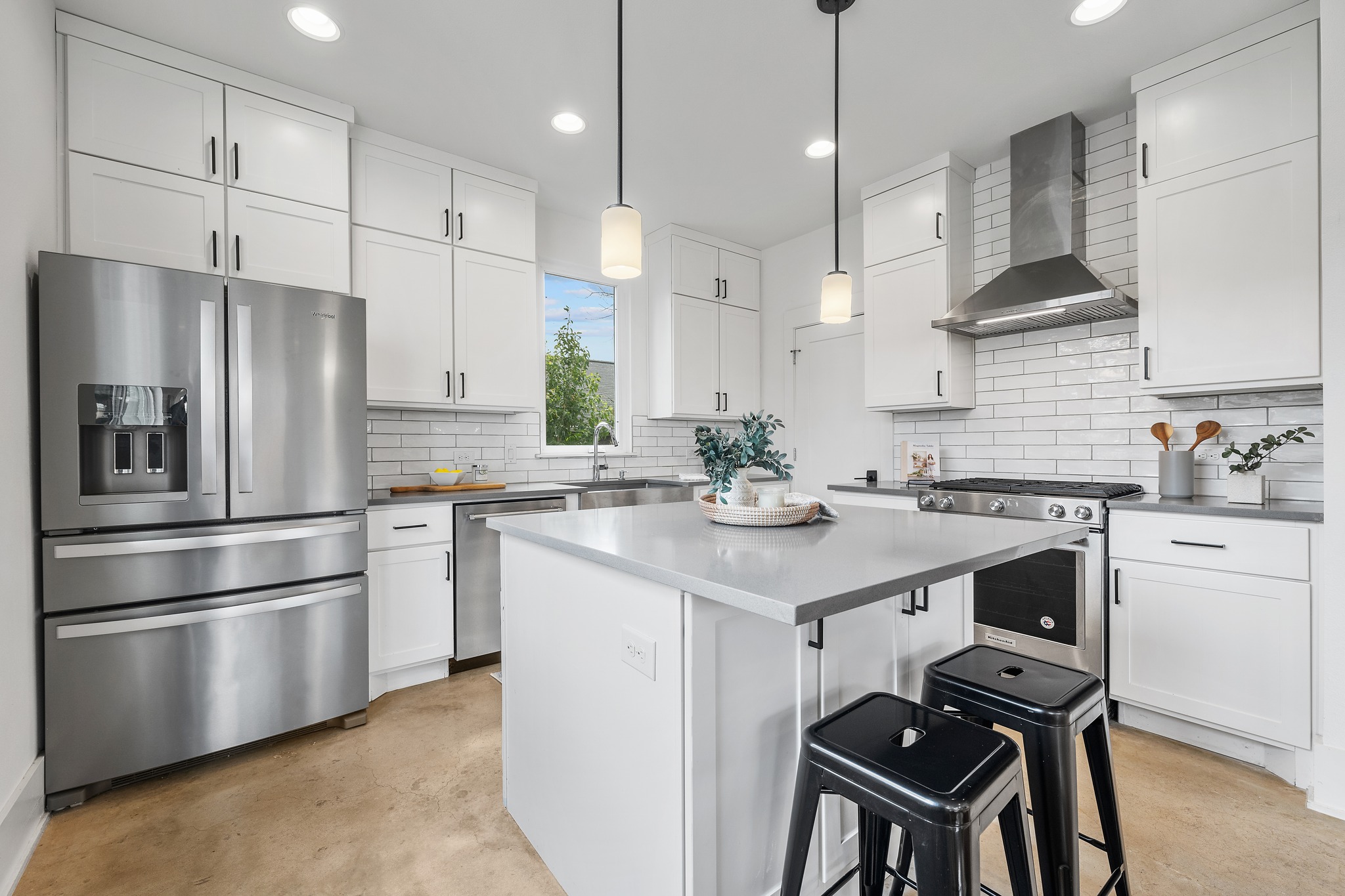 5000 Baker Street Austin, TX 78721 - Photo 3 of 40 Quartz countertops and custom cabinetry give the kitchen a clean, well-built feel while offering generous prep space for daily cooking