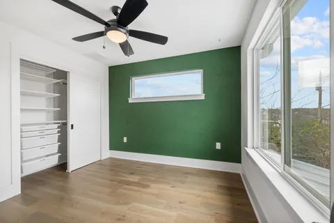 a view of a room with a ceiling fan and a large window