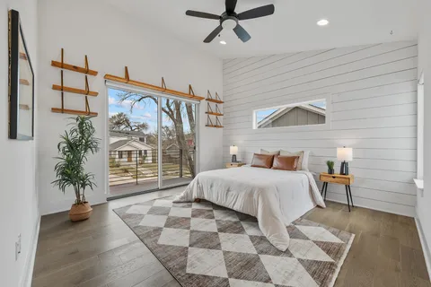a bedroom with a bed and a potted plant