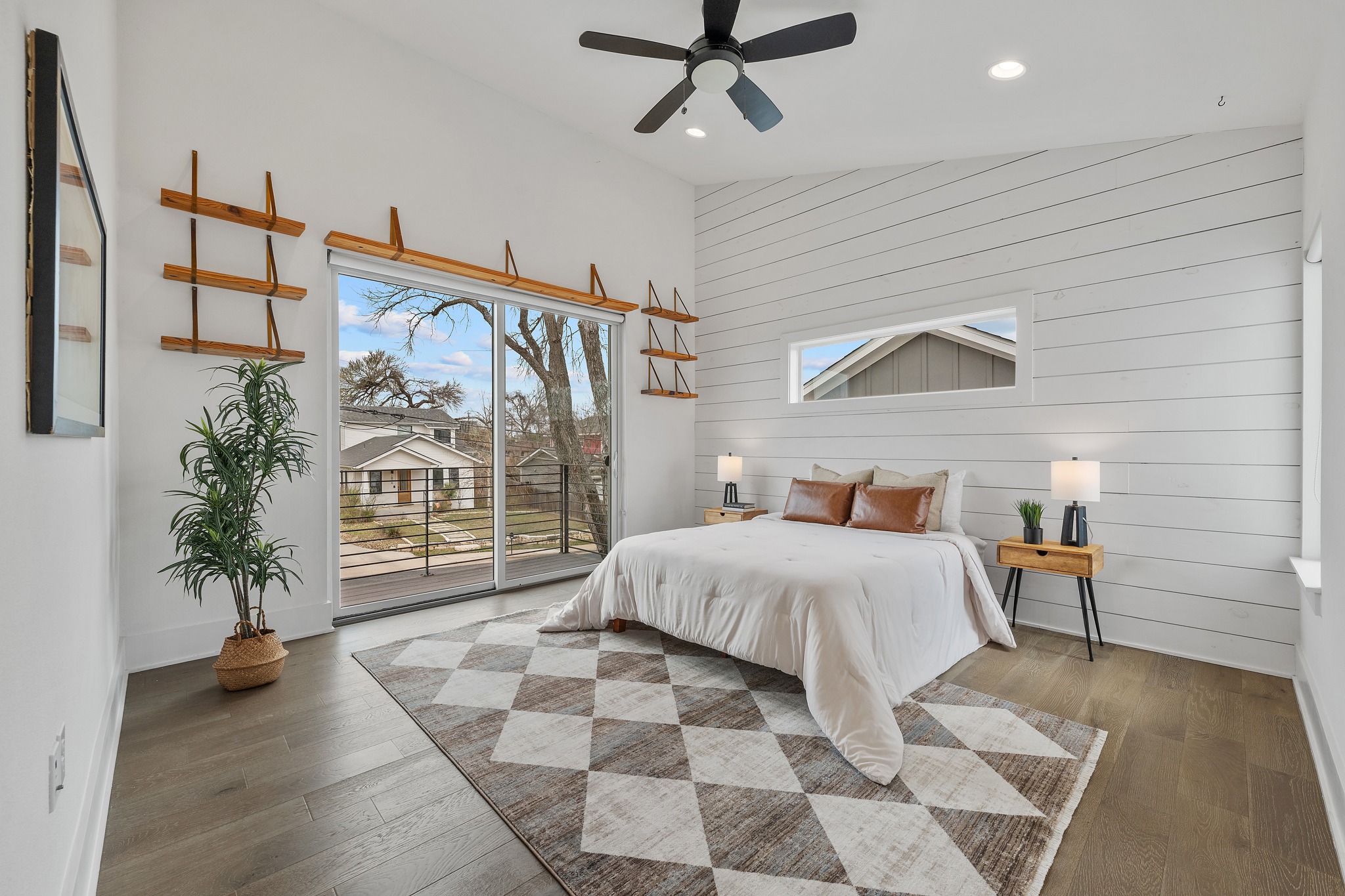 5000 Baker Street Austin, TX 78721 - Photo 4 of 40 Custom natural wood shelving adds both storage and display space, bringing warmth and practicality to the primary bedroom