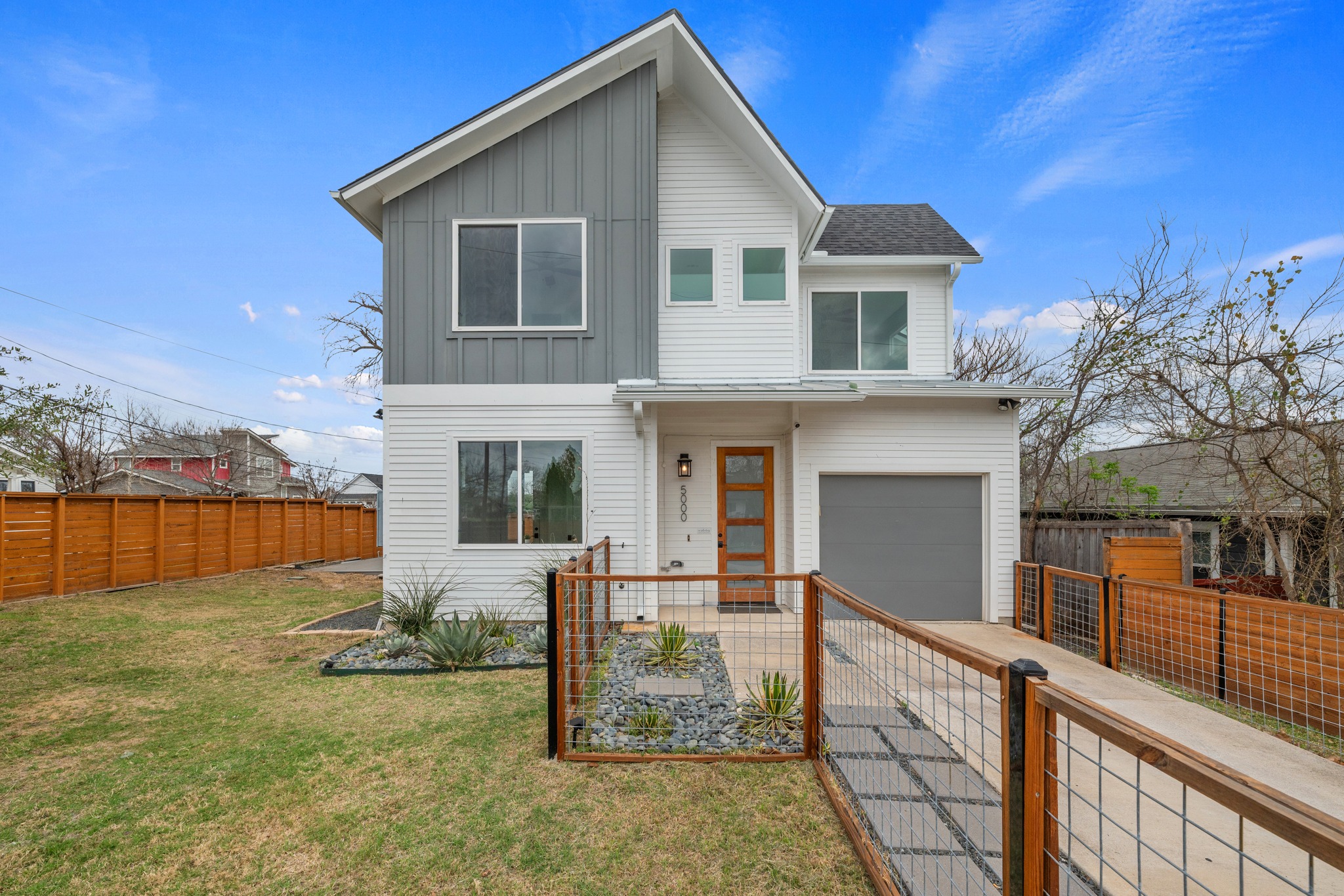 5000 Baker Street Austin, TX 78721 - Photo 9 of 40 The mahogany front door creates a warm first impression, framed by a stained and sealed front fence and expanded patio area that adds usable outdoor space right at the entry