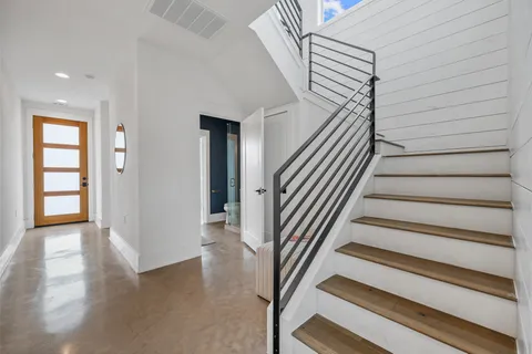 a view of entryway with wooden floor and front door