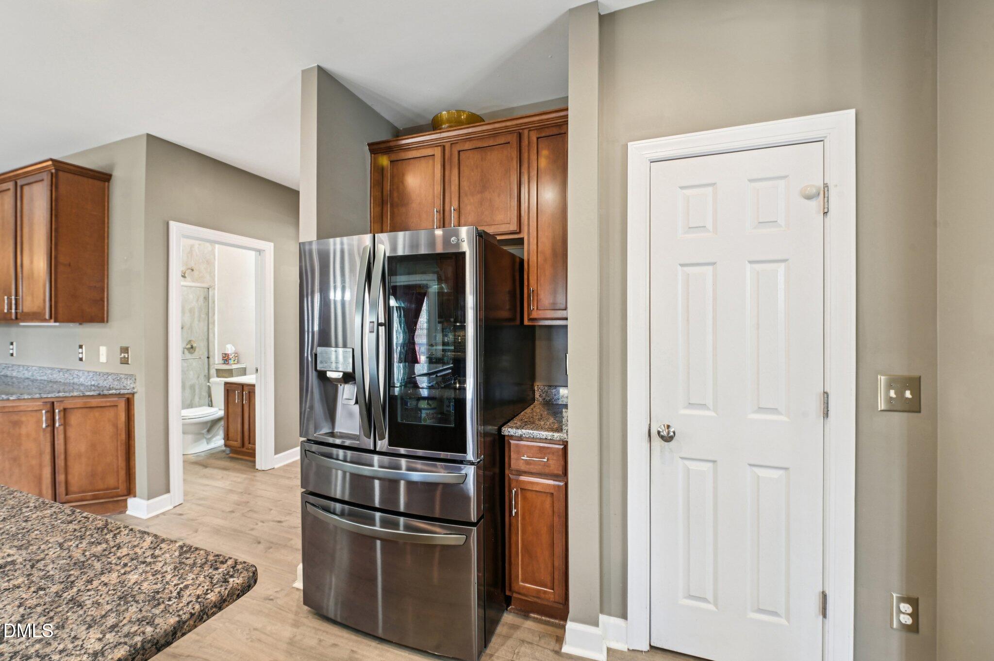 7 Brightfield Lane Durham, NC 27712 - Photo 11 of 41 a kitchen with stainless steel appliances granite countertop a refrigerator and a stove top oven