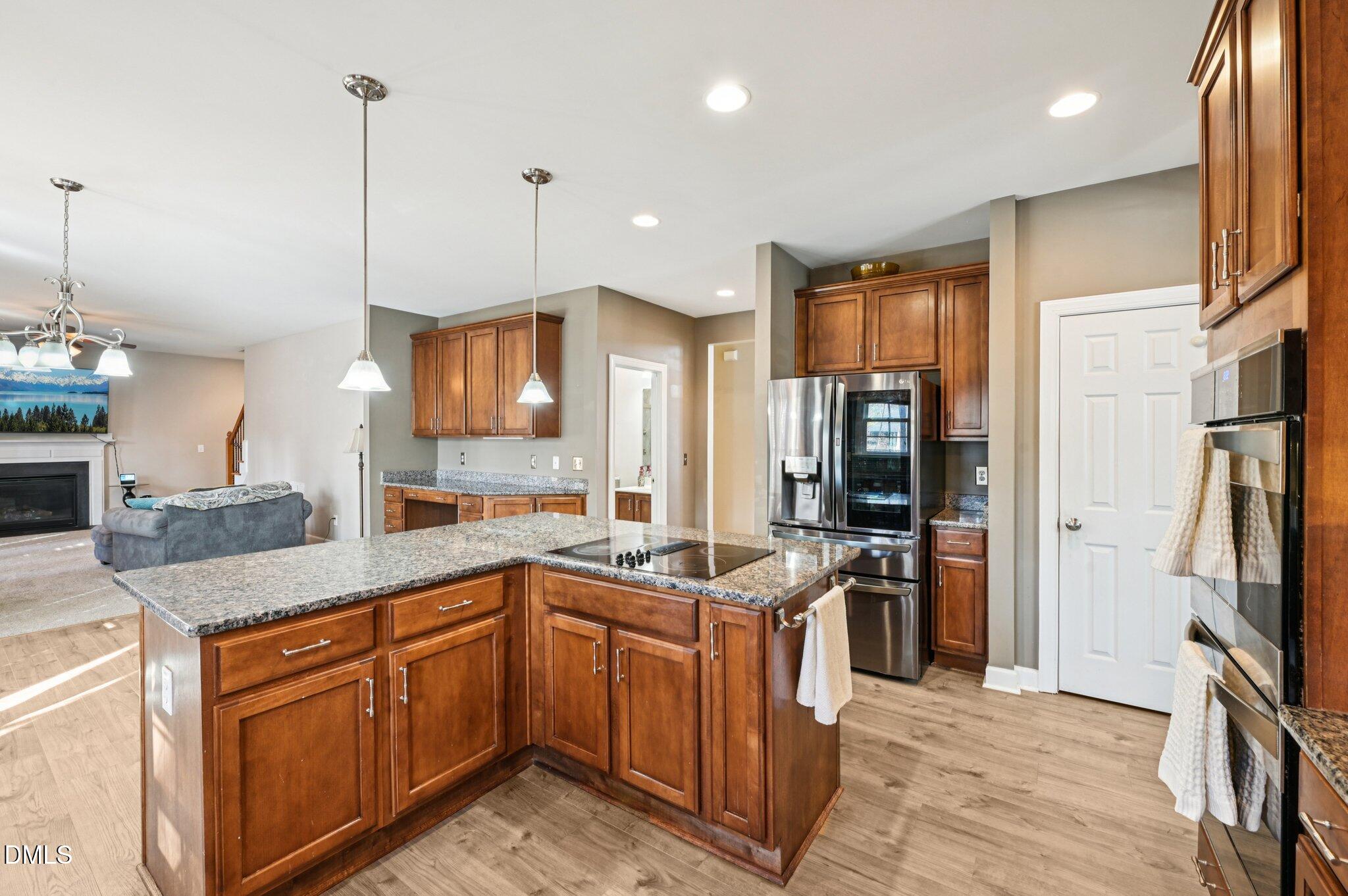 7 Brightfield Lane Durham, NC 27712 - Photo 12 of 41 a kitchen with stainless steel appliances granite countertop a sink a stove and a refrigerator