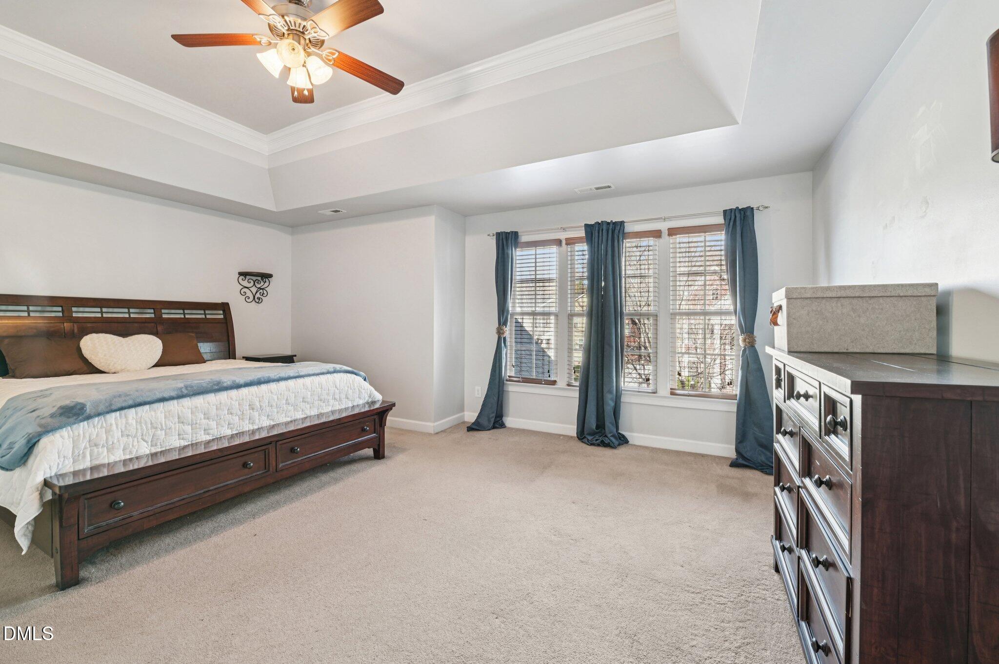7 Brightfield Lane Durham, NC 27712 - Photo 16 of 41 a bedroom with a bed and a chandelier