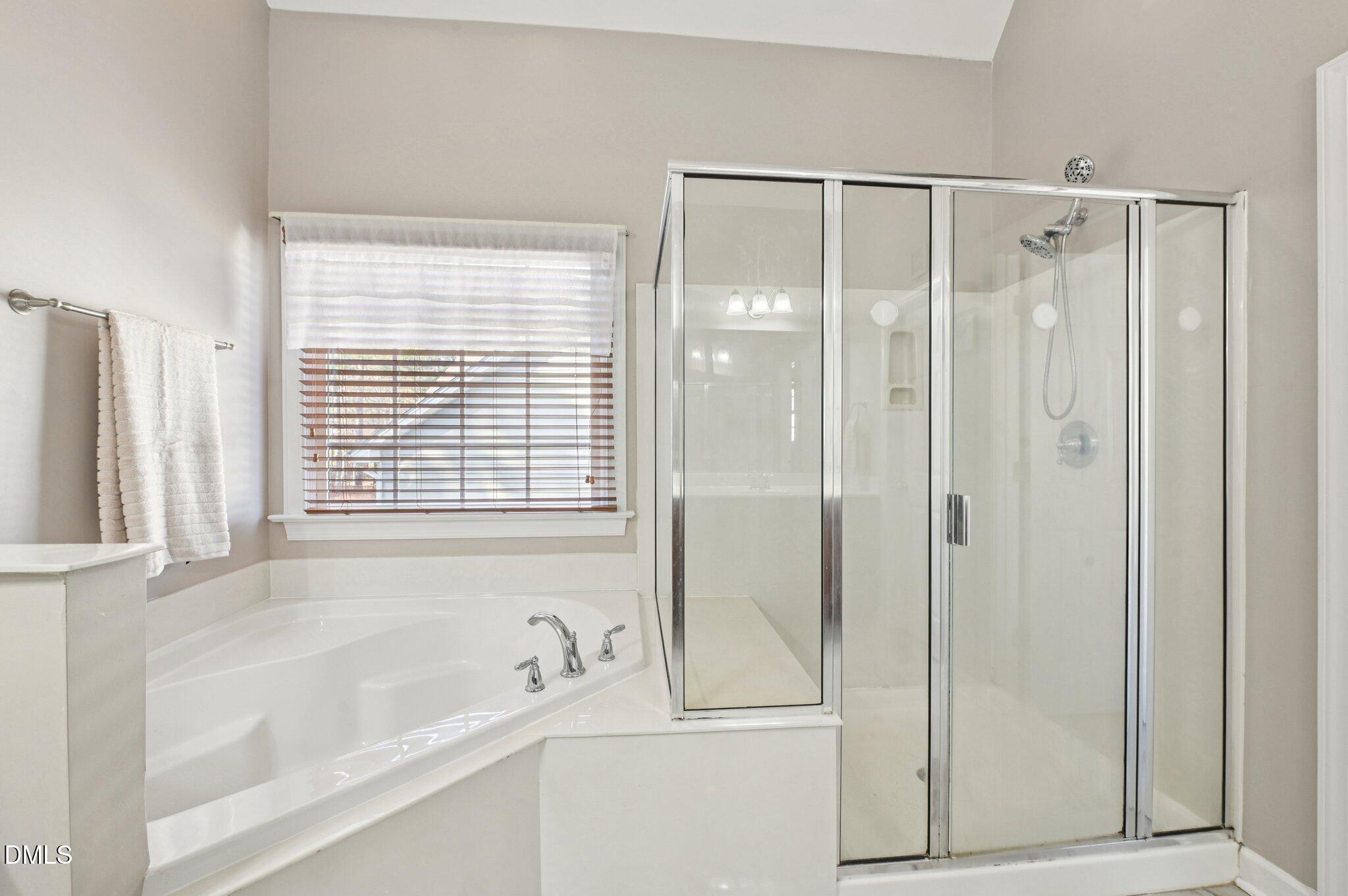 7 Brightfield Lane Durham, NC 27712 - Photo 20 of 41 a bathroom with a bathtub and a shower