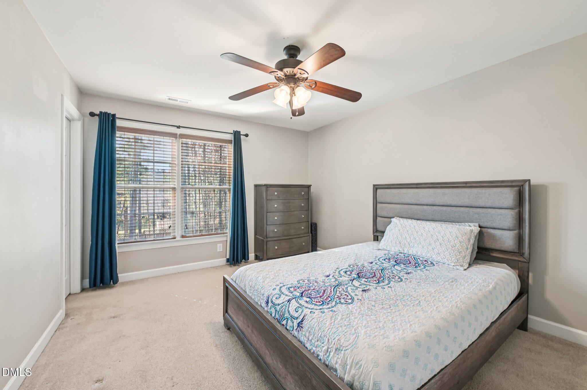 7 Brightfield Lane Durham, NC 27712 - Photo 25 of 41 a bedroom with a large bed and a chandelier