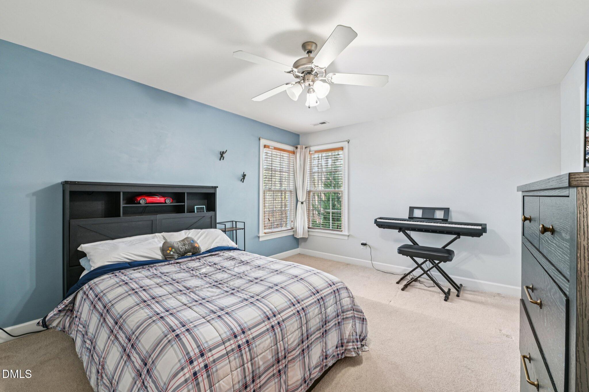 7 Brightfield Lane Durham, NC 27712 - Photo 26 of 41 a bedroom with a bed and a chandelier