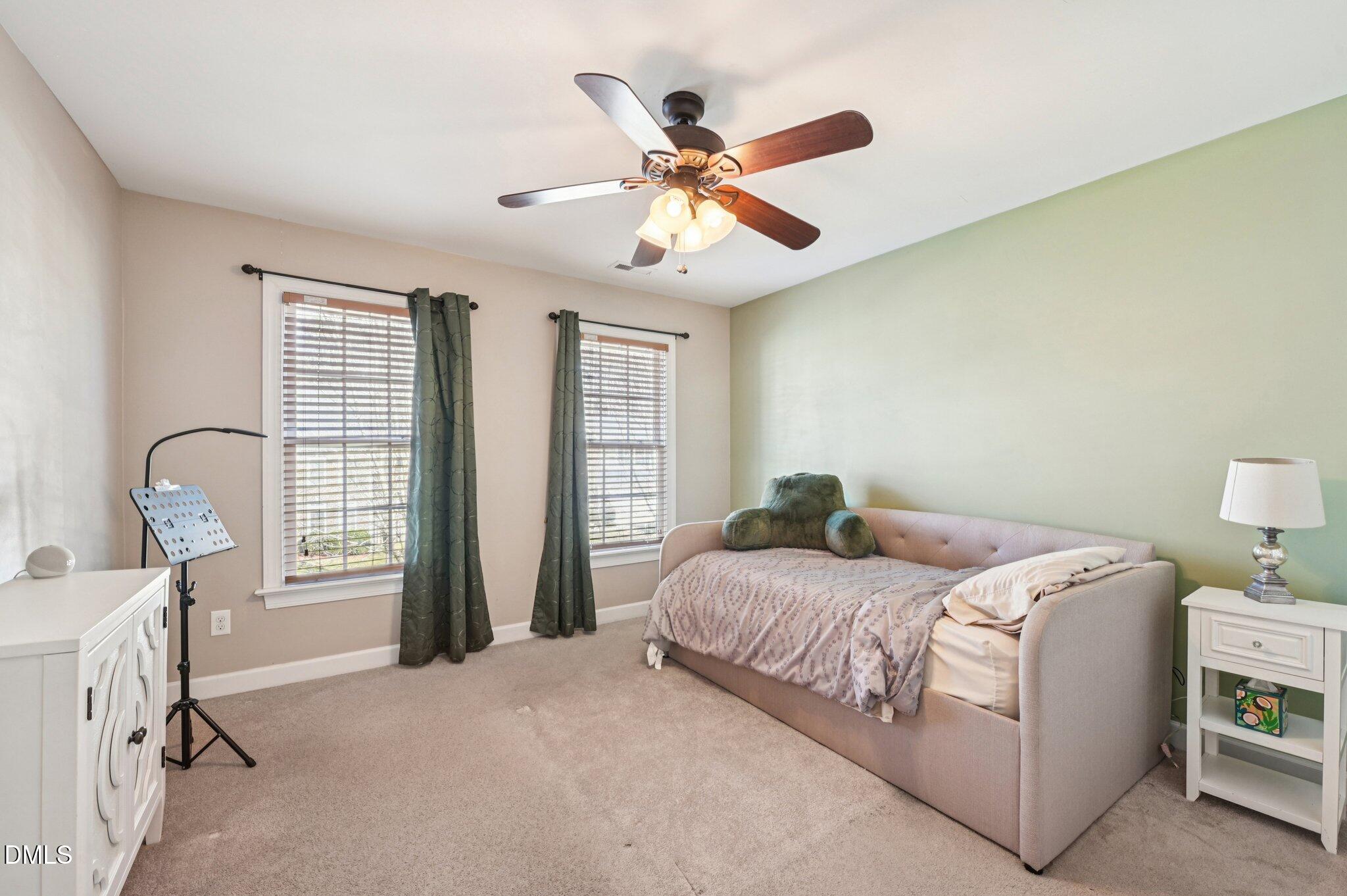 7 Brightfield Lane Durham, NC 27712 - Photo 27 of 41 a bedroom with a bed and a chandelier