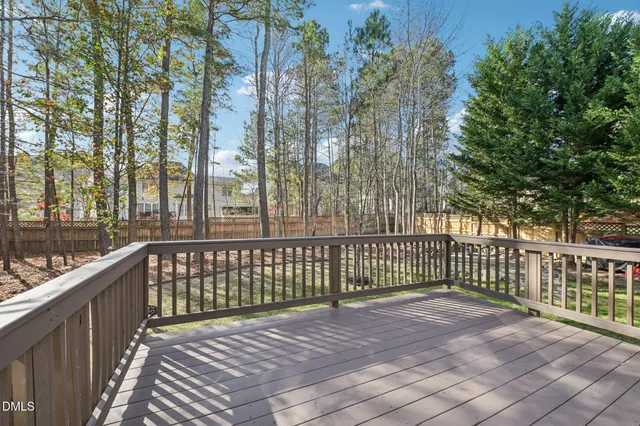 a view of a yard with wooden fence