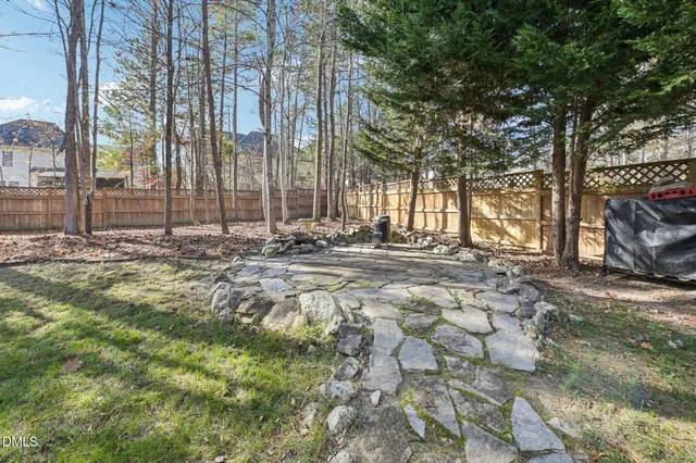 a view of dirt yard with large trees