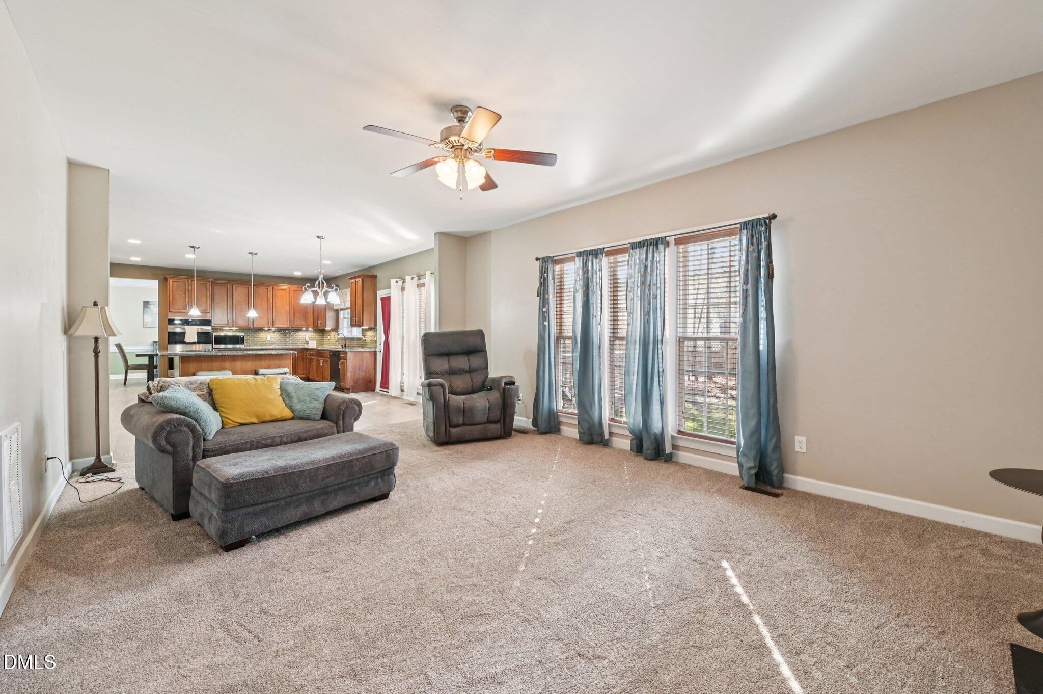 7 Brightfield Lane Durham, NC 27712 - Photo 8 of 41 a living room with furniture and a chandelier