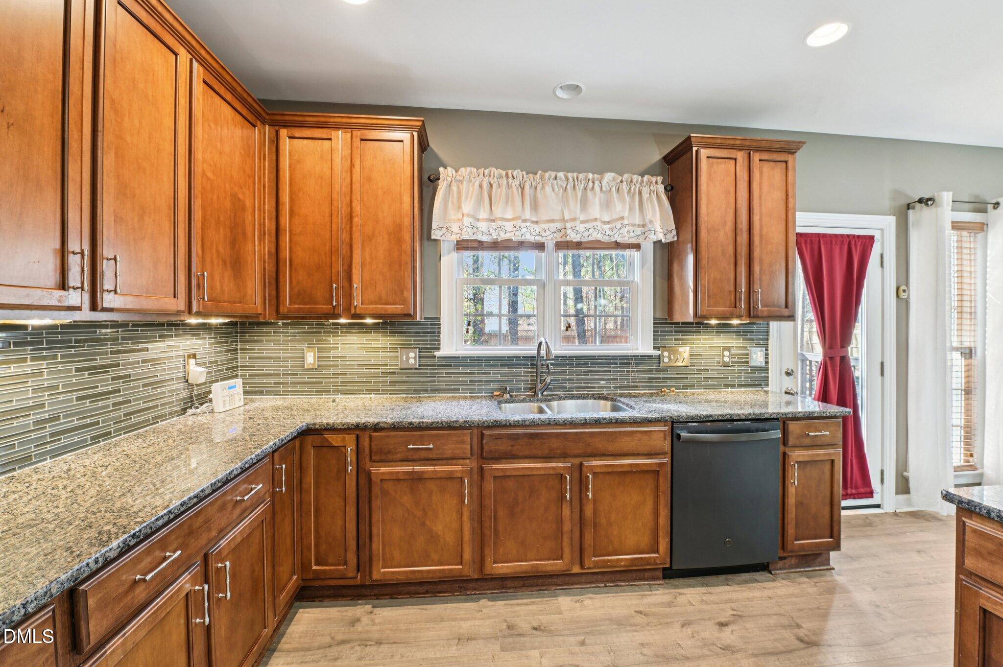 7 Brightfield Lane Durham, NC 27712 - Photo 10 of 41 a kitchen with stainless steel appliances granite countertop a sink a stove and next to a window