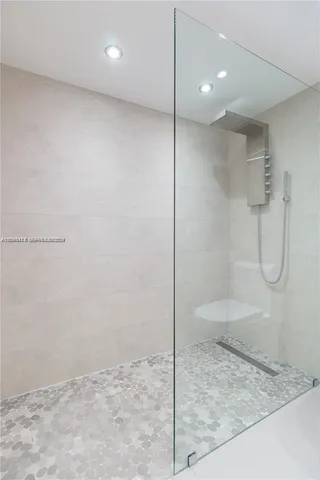 a living room with furniture a flat screen tv and a floor to ceiling window