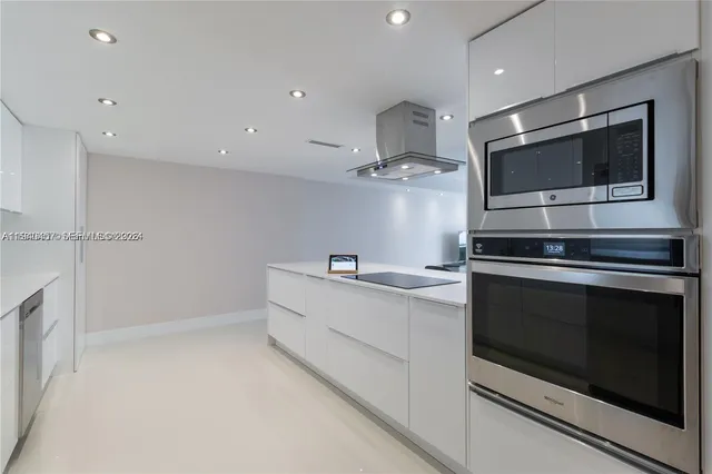 a kitchen with stainless steel appliances a stove microwave and cabinets
