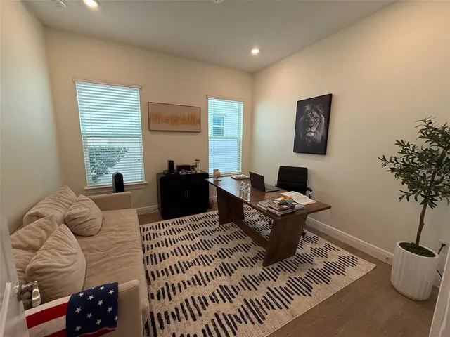 a living room with furniture a rug and a window