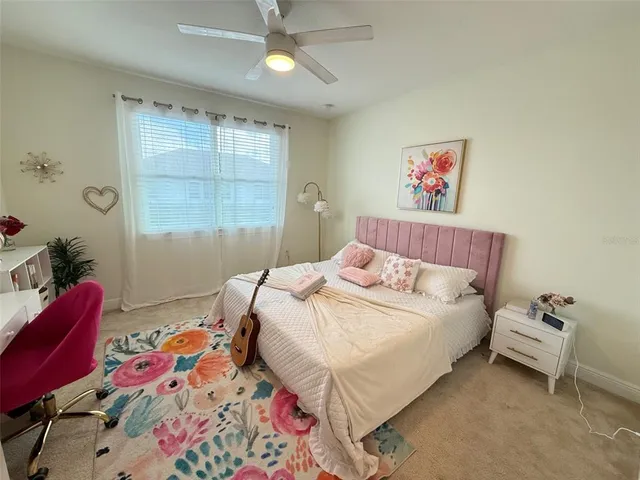 a bedroom with a bed and a painting on the wall