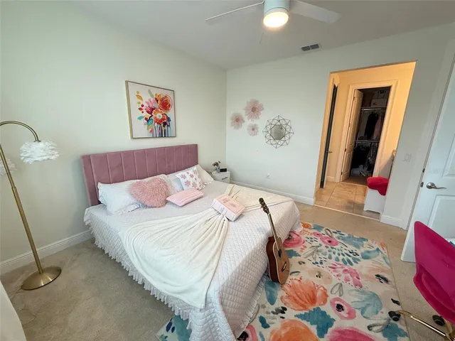 a spacious bathroom with a granite countertop sink a toilet and a mirror