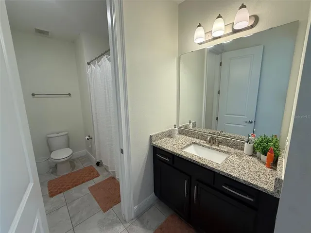 a bedroom with a bed a couch and dresser