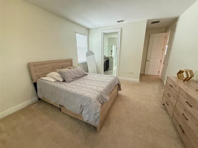 a large bathroom with a granite countertop double vanity sink a mirror and a shower
