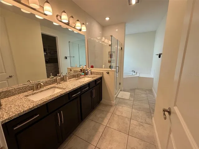 a living room with couch and a ceiling fan