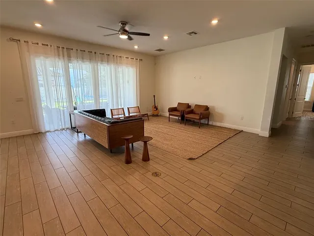 a living room with furniture and kitchen view