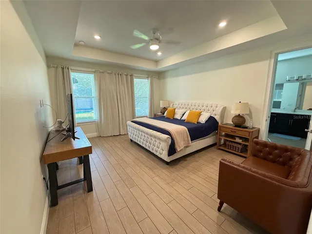 a spacious bathroom with a bathtub sink and mirror