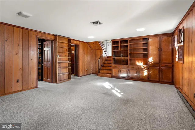 an empty room with furniture and natural light