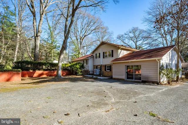 a view of house with backyard and furniture