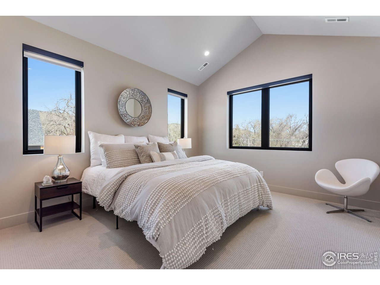 1660 Violet Avenue Boulder, CO 80304 - Photo 18 of 40 a bedroom with a bed and a painting on the wall