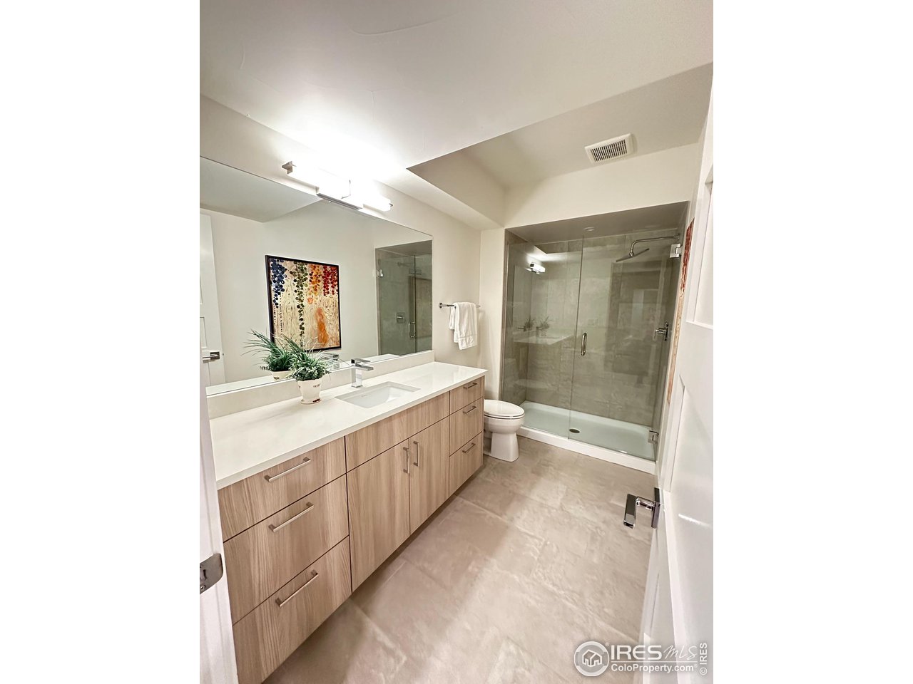1660 Violet Avenue Boulder, CO 80304 - Photo 26 of 40 a bathroom with a double vanity sink and mirror with shower