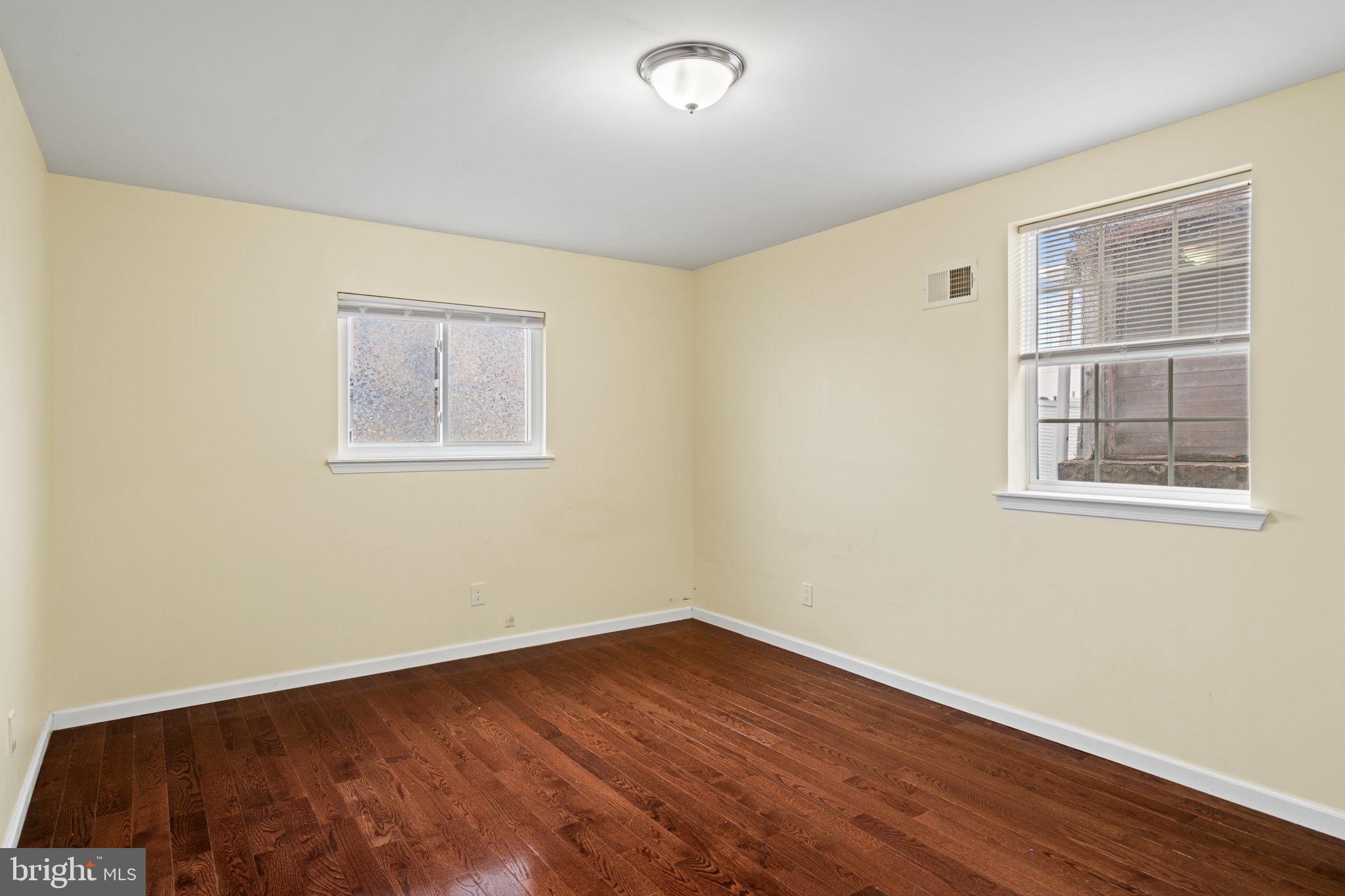 1926 Moore Street Philadelphia, PA 19145 - Photo 17 of 31 a view of an empty room with wooden floor and a window