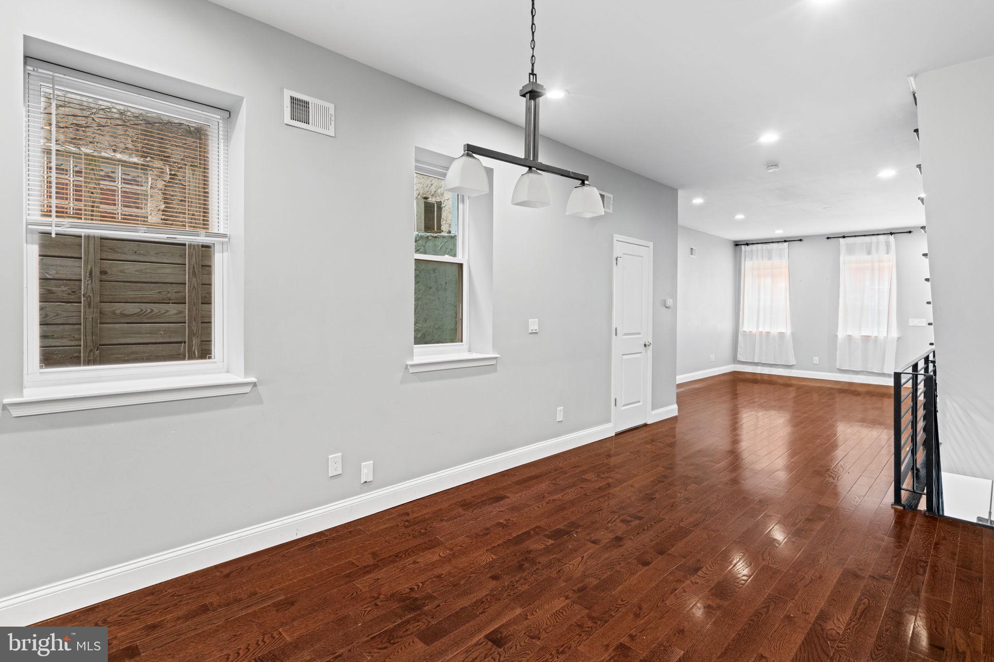 1926 Moore Street Philadelphia, PA 19145 - Photo 8 of 31 a view of empty room with wooden floor and windows
