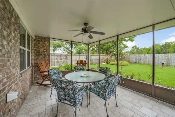 a dining room with furniture and garden view