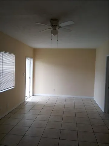 an empty room with a empty space and windows