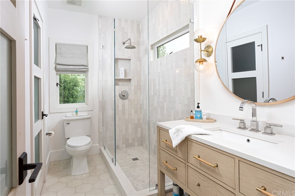 3 Vista Cielo Dana Point, CA 92629 - Photo 16 of 34 a bathroom with a double vanity sink mirror and toilet
