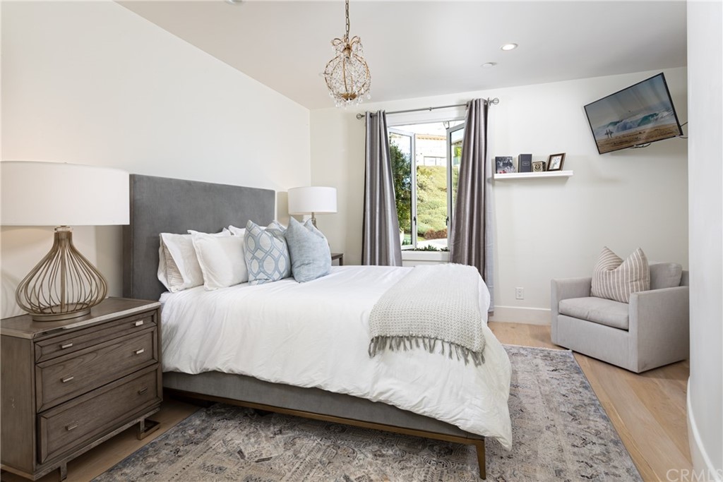3 Vista Cielo Dana Point, CA 92629 - Photo 18 of 34 a bedroom with a bed flat screen tv and window