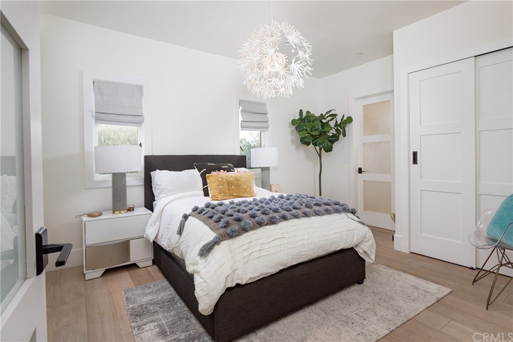 3 Vista Cielo Dana Point, CA 92629 - Photo 21 of 34 a bedroom with bed and a chandelier