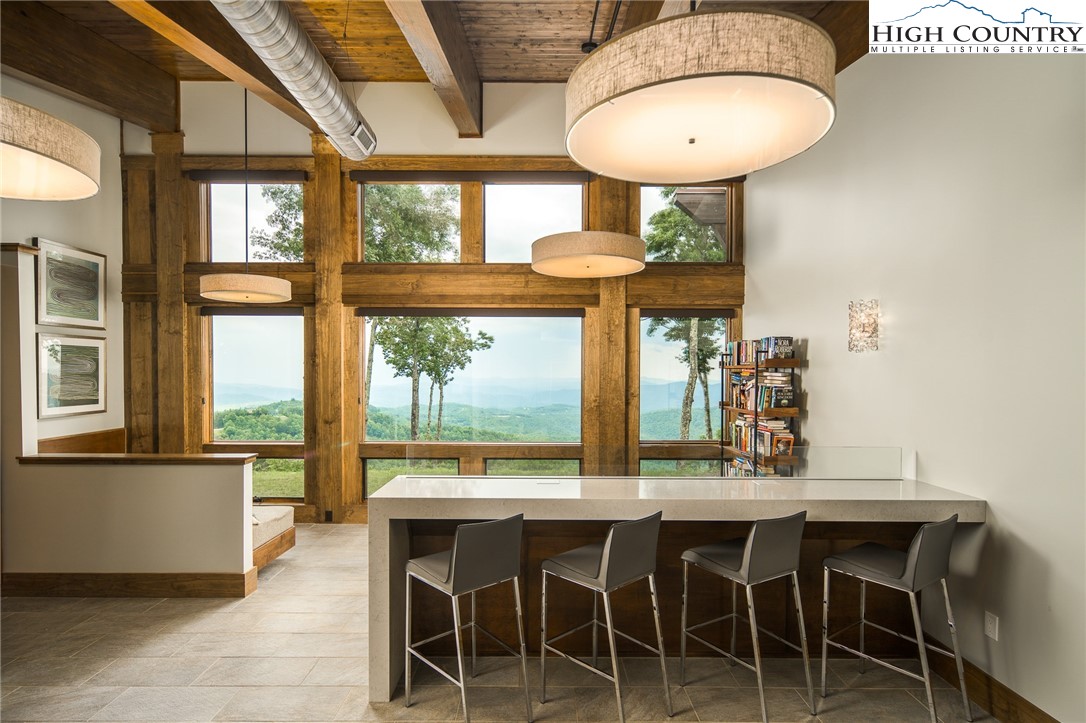 471 Red Cedar Road Boone, NC 28607 - Photo 11 of 31 a dining room with furniture a chandelier and wooden floor
