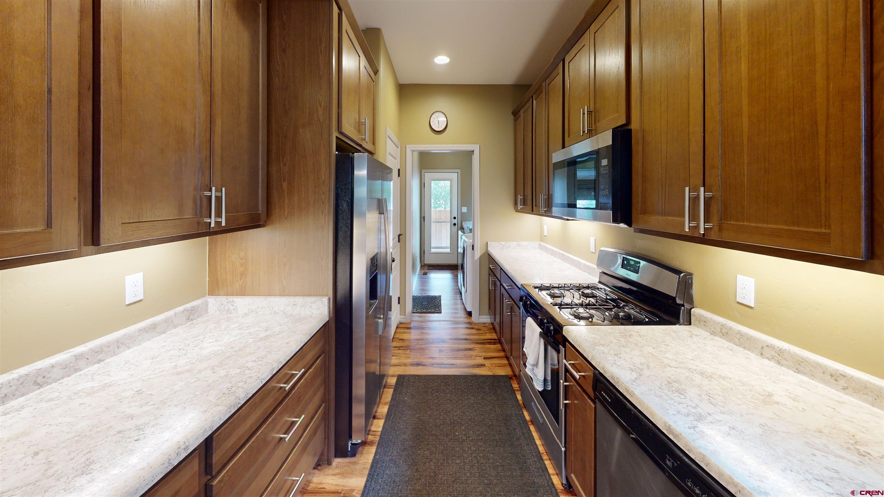 555 Confluence Avenue Durango, CO 81301 - Photo 24 of 27 a kitchen with stainless steel appliances granite countertop wooden cabinets and a stove