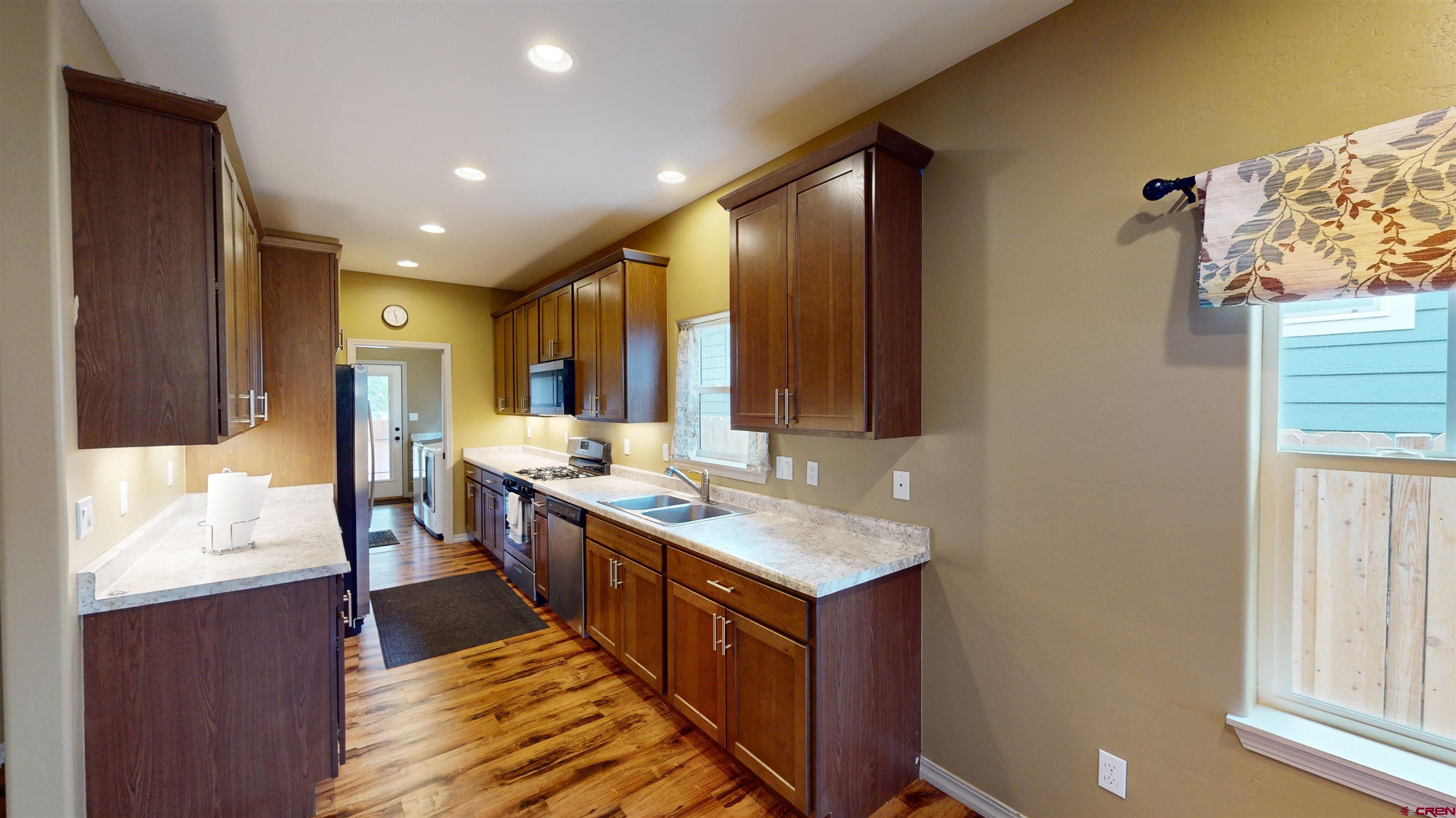 555 Confluence Avenue Durango, CO 81301 - Photo 9 of 27 a large kitchen with stainless steel appliances granite countertop a sink and a stove
